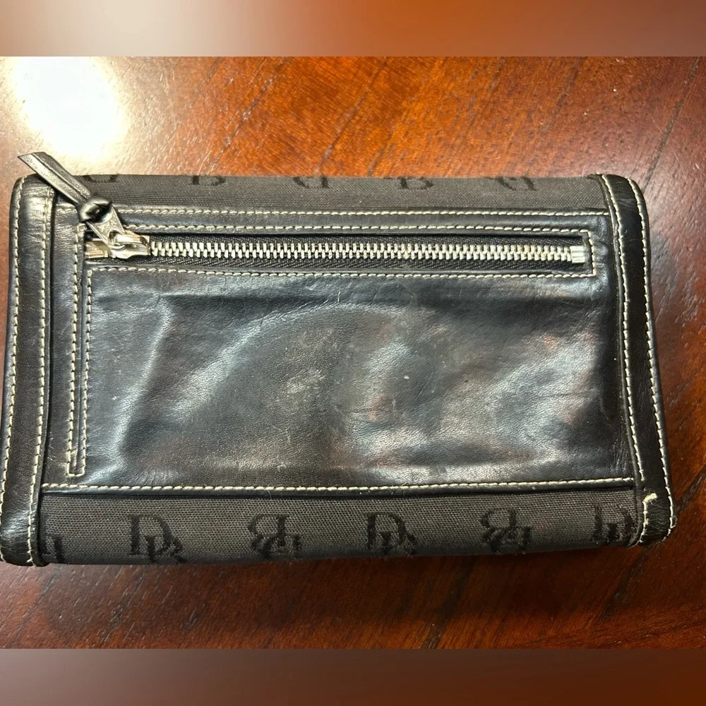 Dooney & Bourke Black Logo Fold Wallet It has a small detail on the inside